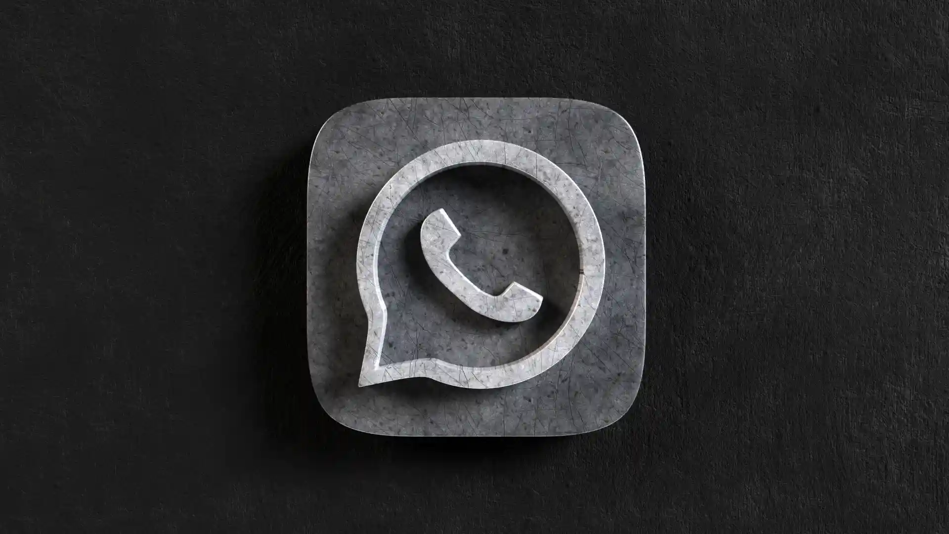 logotipo de WhatsApp sobre piedra